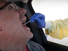 A man gets a drive-thru COVID-19 test at an Alberta Health Services testing site.