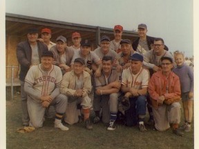 2009.014.122 - In an undocumented year and location, baseball “boys” from different teams, although adversaries on the field of play, get together for a tournament celebratory photograph. Back Row: ---, Lloyd Devine, Al Adair (red CKYL cap), ---. Mid-row: ---, Cec Swanson, John Czuy, ---, Adam Becker, Tommy Tucker (for whom annual, since 1971, Bantam Hockey Tournament is named). Front Row: Marshall Bekevich, Dave Sneddon, John MacMillan, Glenn Murphy, Albert Bell and unknown young boy. If anyone is able to identify unknown players, year and location of photograph, please let Museum staff know.