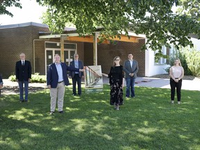 Premier Jason Kenney and Dr. Alice Wainwright-Stewart share a rendering of the renovated WHT Mead Animal Science Centre. They're joined by agricultural sciences students TJ Gonsalves (front row left) and Rianne Harrish (front row right) as well as Lakeland's board chair Scott Webb, Garth Rowswell, MLA for Vermilion-Lloydminster-Wainwright, and Demetrios Nicolaides, Minister of Advanced Education (back row from left).