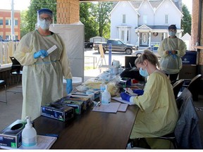 Sonia Teeuwen (left), a registered nurse with the Erie St. Clair LHIN, is among the health care workers helping with extra COVID-19 testing that's being conducted outdoors at the Chatham-Kent Health Alliance’s COVID-19 assessment centre on Emma Street in Chatham. Held in partnership with Chatham-Kent EMS, the centre saw nearly 500 people show up on Aug. 4. Ellwood Shreve/Postmedia Network