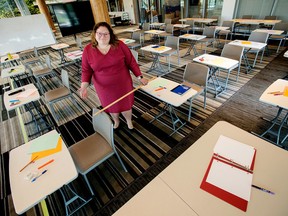 Alberta NDP Education Critic Sarah Hoffman poses in a makeshift classroom, created to illustrate the difficulties teachers and students will face in observing COVID-19 social distancing rules during a return to school this fall, in Edmonton Tuesday, August 11. DAVID BLOOM/Postmedia