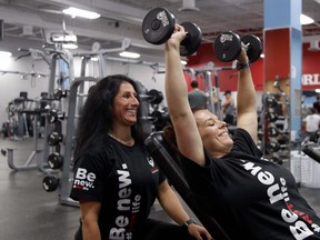 Monique Cormier, left, guides Jessica Patterson through an exercise, Friday, at World Gym. Patterson is set to be featured on an upcoming episode of the Amazon Prime series Radical Body Transformations. Michael Lee/The Nugget