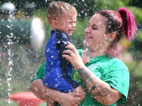 Lucas Thibodeau, 22 months, makes his first visit to the Bellevue Park splash pad with his mother, Cydney Thibodeau, on Saturday, Aug. 15, 2020 in Sault Ste. Marie, Ont. Lucas likes water, just not when it comes and goes like it does at the splash pad. (BRIAN KELLY/THE SAULT STAR/POSTMEDIA NETWORK)