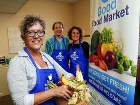 Brenda Foran, foreground, Jim Mallabar and Jennifer Allen promote the Good Food Market Tuesday, September 3, 2019 at the Community Development Council of Quinte in Belleville. Markets are now on hold, but the council is still providing fresh produce. The program needs a new space in which to pack its food bags.