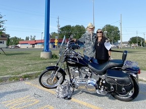 James Guzi, alongside wife Vicky, emerged with the winning bid for a 2007 Harley-Davidson FXST Soft Tail during an auction supporting Habitat for Humanity Sarnia-Lambton. Handout