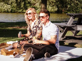 MaryAnn Brown and Ian Penner enjoy some alcoholic beverages with their takeout meals from Pazzo Taverna and Pizzeria on Tom Patterson Island. Photo by Larry McCabe