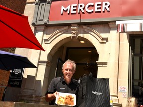Stratford Perth Museum general manager John Kastner shows off the fried chicken dinner that will be available for takeout from Mercer Kitchen and Beer Hall – one of six participating downtown restaurants -- during the museum’s Outkeepers’ Dinner fundraiser on Sept. 16. As a bonus, the first 50 customers who order at least two meals as part of the fundraiser dinner will also receive a Perth County Tourism insulated travel bag for meals on the go. Galen Simmons/The Beacon Herald/Postmedia Network