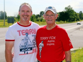 Jeff Sawkins stands with his father, retired OPP officer Wally Sawkins, along Highway 7 outside Madoc. Wally, with Jeff at his side, escorted Terry Fox through the area during the original 1980 Marathon of Hope. On Sept. 20, Jeff will run the same stretch of highway to raise funds for cancer research and honour his father's own fight against cancer.