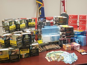 Unstamped contraband cigarettes, cigars and loose tobacco, and cash were seized by Ontario Provincial Police when they executed a search warrant at a business in Sharbot Lake on Thursday. (Supplied Photo)