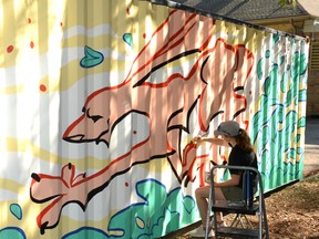 Gallery Stratford summer student Josslyn Hagen works on the forest-themed mural she's painting on one side of a storage container behind the gallery building. Galen Simmons/The Beacon Herald/Postmedia Network