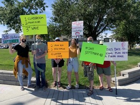 About 80 protestors marched outside of local MLAs Nate Glubish and Jordan Walker's constituency offices on Friday, August 21. Many believed the province's plan will not be enough to keep students and teachers safe this fall during the COVID-19 pandemic. Lindsay Morey/News Staff