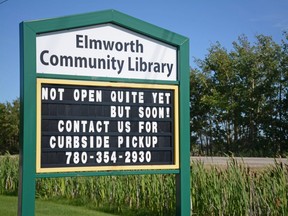 A sign for the Elmworth Community Library in Elmworth, Alta. on Saturday, July 25, 2020. The library was closed due to the COVID-19 pandemic but still offered curbside pickup.