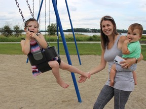 Hillary Sabourin, was enjoying the cloudy mix of warm weather at Porcupine Lake on Monday afternoon, along with her daughter, Rylee Sabourin, 4, on the swing and her son, Dax Sabourin, 1. The weather changed later in the day, of course, with thunderstorms rolling through the city. RICHA BHOSALE/THE DAILY PRESS/POSTMEDIA NETWORK