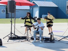 Human bees Gayle Beuermann (left) and Glenda Kemp buzz around entertainer Adam Lang during the scaled down version of the 164thth Bayfield Community Fair held on Aug. 14. Handout