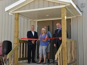 A new expansion portable for high school aged students was unveiled during a ribbon cutting ceremony on Aug. 21 at Brant Christian School. Here, Chair of the Brant Christian Society Board – Tonia Kohls, cuts the ribbon alongside (left) Palliser School Division Superintendant Dave Driscoll and (right) Palliser School Division Trustees Chair Robert Strauss.