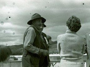 1976.704.001 – Joe Erwin, a.k.a. Tarnation Pard, in foreground, chats with Cliff Vangrud and Shirley (Iverson) Ford during a 1975 St. Augustine Mission reunion on Shaftesbury Trail.