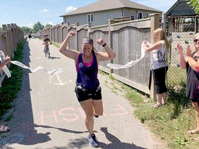 Tara Antle crosses the finish line during her first half-marathon on July 25. Photo submitted by John Barker