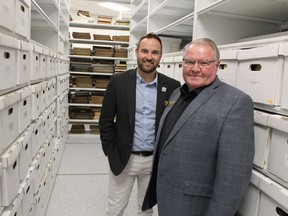 Andrew Meyer (left), general manager of Lambton County's cultural services division, and county Warden Bill Weber are shown in this file photo at county archives. It's one of the county services closed to the public by COVID-19 restrictions. File photo/Postmedia Network