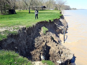 Keagan Chambers walks along the eroded shoreline at Wheatley Provincial Park on May 14, 2019. IThe Ontario government on Aug. 14 launched its first-ever climate change impact assessment to better understand where and how climate change will affect "communities, critical infrastructure, economies and the natural environment." File photo/Postmedia Network