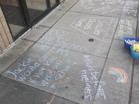 Chalk messages were left outside Fort Saskatchewan-Vegreville MLA Jackie Armstrong-Homeniuk’s Fort Saskatchewan office on Friday, August 21 as part of a province-wide protest against the UCP school re-launch plan. Photo Supplied.