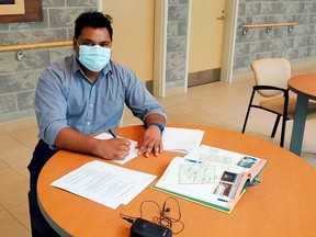 Dr. Niteeshan Singaram signs his contract with Hastings County and Greater Napanee. He's the latest family doctor recruited through a municipal partnership.