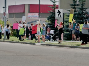 Beaumontonians held a protest outside Leduc-Beaumont MLA Brad Rutherford's office on Friday, Aug. 21 to ask the province for further educational funding for educational programs and more educational assistants in the classrooms once students go back to school in September.
(Alex Boates)