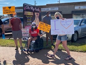 Residents gathered outside of MLA Searle Turton's office in Spruce Grove to protest the UCP school relaunch plan.
