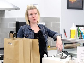 Aimee Hennig adjusts merchandise in her presently-closed The Play Café in Spruce Grove. She is puzzled by the situation she finds herself in and worries about the future of her economic baby as the pandemic days drag on.