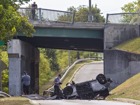 A team from the Ontario Special Investigations Unit examine the scene of a single-vehicle crash on Paris Road at the CN rail overpass in Brantford, Ontario on Saturday morning.