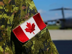 A Canadian Armed Forces member stands near a CC-177 Globemaster III at CFB Trenton Saturday.