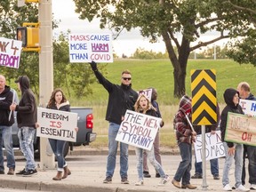 More than 100 people protest a proposed mandatory mask bylaw near Centre 2000 in Grande Prairie, Alta. on Monday, Aug. 21, 2020.