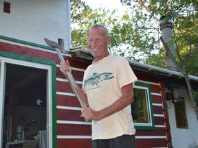 The late Tim Dodd, who was featured in a Sudbury Star story in 2018, shows off an old axe he found on his property at Panache Lake. The Lively resident died a week ago from a heart attack he experienced at camp and his family is now raising money to purchase a defibrillator for the cottage community.