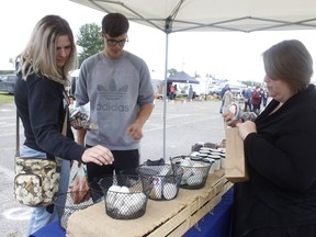 Emilie Roy along with her boyfriend, Jonathan McLean, checked out some of the variety of soaps on display at one of the booths during the Mountjoy Farmers’ Market on the weekend. Kyla Bondy-Montgomery, owner of Sacred North Soap, was on hand to provide details on the items she had for sale. RICHA BHOSALE/THE DAILY PRESS/POSTMEDIA NETWORK