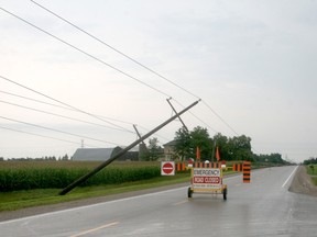 Several hydro poles were knocked over during a storm east of Mount Carmel on Aug. 27. The road was closed while hydro crews worked to restore power. Scott Nixon