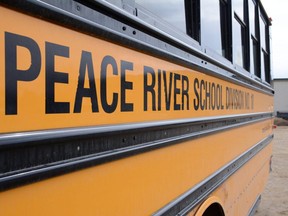 A bus is parked at the Peace River School Division's Central Operations building in Grimshaw, Alta.
