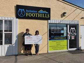 Organizer of the 100 Women Who Care Foothills – Julie Boake (left), came out to the Inclusion Foothills office in High River on Aug. 28 and presented a cheque for $8,925 to Kathy Thornhill of Inclusion Foothills