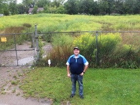 Steve Pratt, the president of the Opportunity Villages Community Land Trust board of directors, stands in front of the 2.5-acre site on Taylor Avenue in Chatham, where an affordable housing project is to be developed. Ellwood Shreve/Postmedia Network