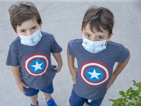 Four-year-old twins Joaquin and Dante Bagur wear masks in in London on Aug. 25. Derek Ruttan/Postmedia Network