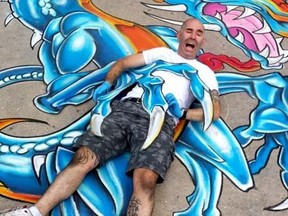 The Neon Crab's Will Graham pictured with a chalk dragon he created during a street art competition in London in 2014. He's holding a similar competition in Sarnia on Sept. 26. Submitted