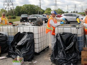 Vehicles were lined up to get into the public works yard on Creek Road in Chatham to drop off various oils, solvents and other hazardous materials during a past hazard waste day collection. From left are Drew Watts, Tyler Hiller and Dave Better. The hazardous waste day scheduled for Sept. 12 has been postponed because of the pandemic. Ellwood Shreve/Postmedia Network