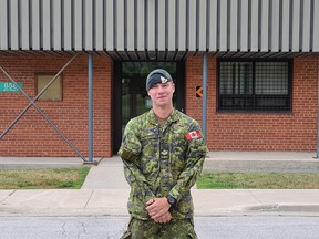 Portrait of MCpl Fischer in front of Tommy Holmes, VC Memorial Armoury, in Owen Sound. Cody Misner photo.