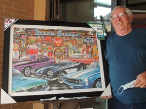 Auxiliary member Bill Lackner stands with the latest print, entitled "Dream Garage" by Dean Russo.