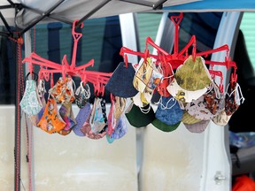 A hangar of masks sit on display at an outdoor market. The Town of Stony Plain recently passed a bylaw requiring the wearing of these garments in public if the community falls under a COVID-19 "watch" designation during a special meeting Monday.