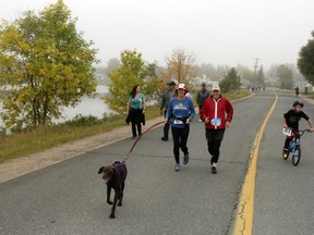 Tucker leads Edie Fisher of Kenora with Frank Bright from Shreveport, Louisiana during 2019's annual Terry Fox Kenora Community Run. This year's run will be held virtually and encourages people to run wherever they can to support the Terry Fox Foundation.