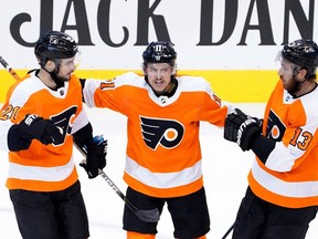 Philadelphia Flyers' Scott Laughton (21) celebrates with Travis Konecny (11) and Kevin Hayes (13) after scoring against the Washington Capitals during the third period in an Eastern Conference round-robin game during the 2020 NHL Stanley Cup playoffs at Scotiabank Arena on August 6, 2020, in Toronto. (Photo by Andre Ringuette/Freestyle Photo/Getty Images)