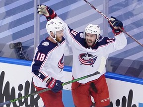 Liam Foudy, right, of the Columbus Blue Jackets celebrates his third-period goal with Pierre-Luc Dubois in Game 5 of the Eastern Conference Qualification Round against the Toronto Maple Leafs on Aug. 9 at Scotiabank Arena in Toronto. (Andre Ringuette/Freestyle Photo/Getty Images)