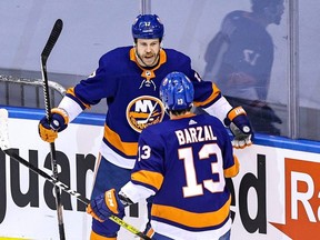 New York Islanders' Matt Martin, left. is congratulated by his teammate, Mathew Barzal, after scoring a goal against the Philadelphia Flyers during the second period in Game 3 of the Eastern Conference second round during the 2020 NHL Stanley Cup playoffs at Scotiabank Arena on August 29, 2020, in Toronto, Ontario. (Photo by Elsa/Getty Images)