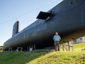 Ian Raven, executive director of the Elgin Military Museum, stands in front of the newly painted HMCS Ojibwa in Port Burwell. Retired submariners, veterans and members of Team Rubicon, the Canadian Heroes Foundation, Eastern Ontario, and the Canadian Forces volunteered to help repaint the vessel for its reopening with volunteers travelling from Ottawa, Kingston, Coburg, Oshawa, Peterborough, Hamilton, London, Port Dover and Niagara. (Max Martin/The London Free Press)