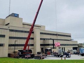 The new MRI is lifted by crane into the Owen Sound hospital on Tuesday.
