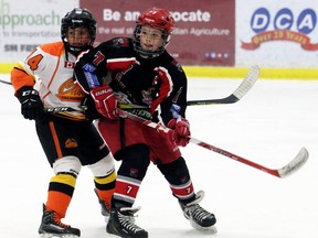 Chatham-Kent Cyclones' Colton Graham, right, battles Elgin-Middlesex Chiefs' Liam Brulotte during Game 4 in the Alliance Hockey minor peewee 'AAA' playdown final at Blenheim Memorial Arena in Blenheim, Ont., on Sunday, March 19, 2017. Mark Malone/Chatham Daily News/Postmedia Network